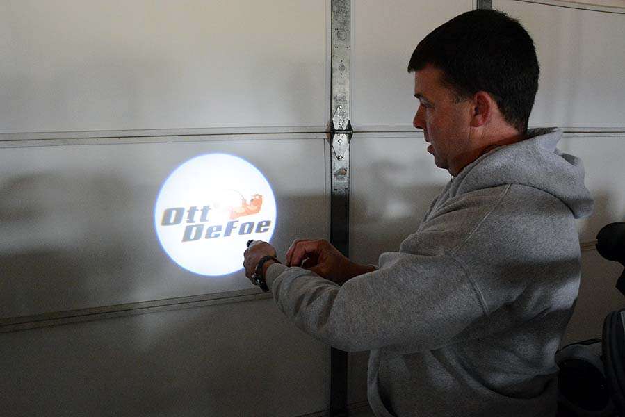 When DeFoe opens the truck door the ground surrounding it will illuminate with his brand logo. Hampton is only testing the light with a 9-volt battery. When connected to the 12-volt battery in the truck it will shine much brighter and wider. 