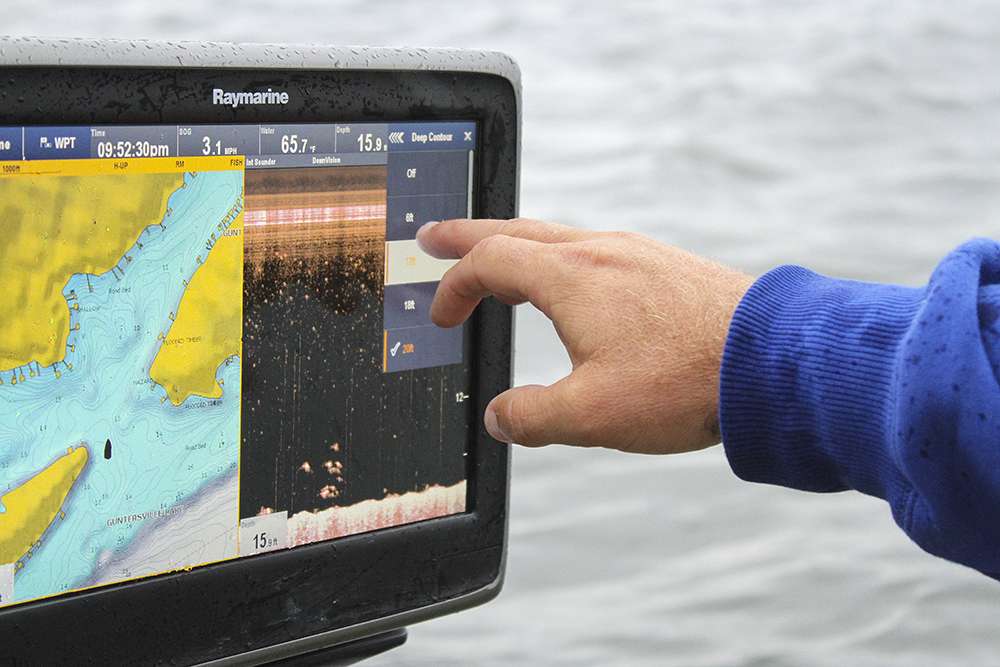 Raymarine features a mapping system with contour highlights. Here the blue is everything shallower than 20 feet of water. He changes it to 12 to show accurate contour detail in the back of this cove.