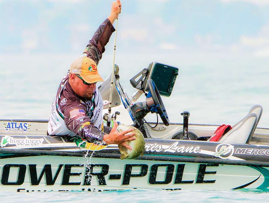 Chris Lane struggles to gain control of a smallmouth near the boat on Lake St. Clair. 