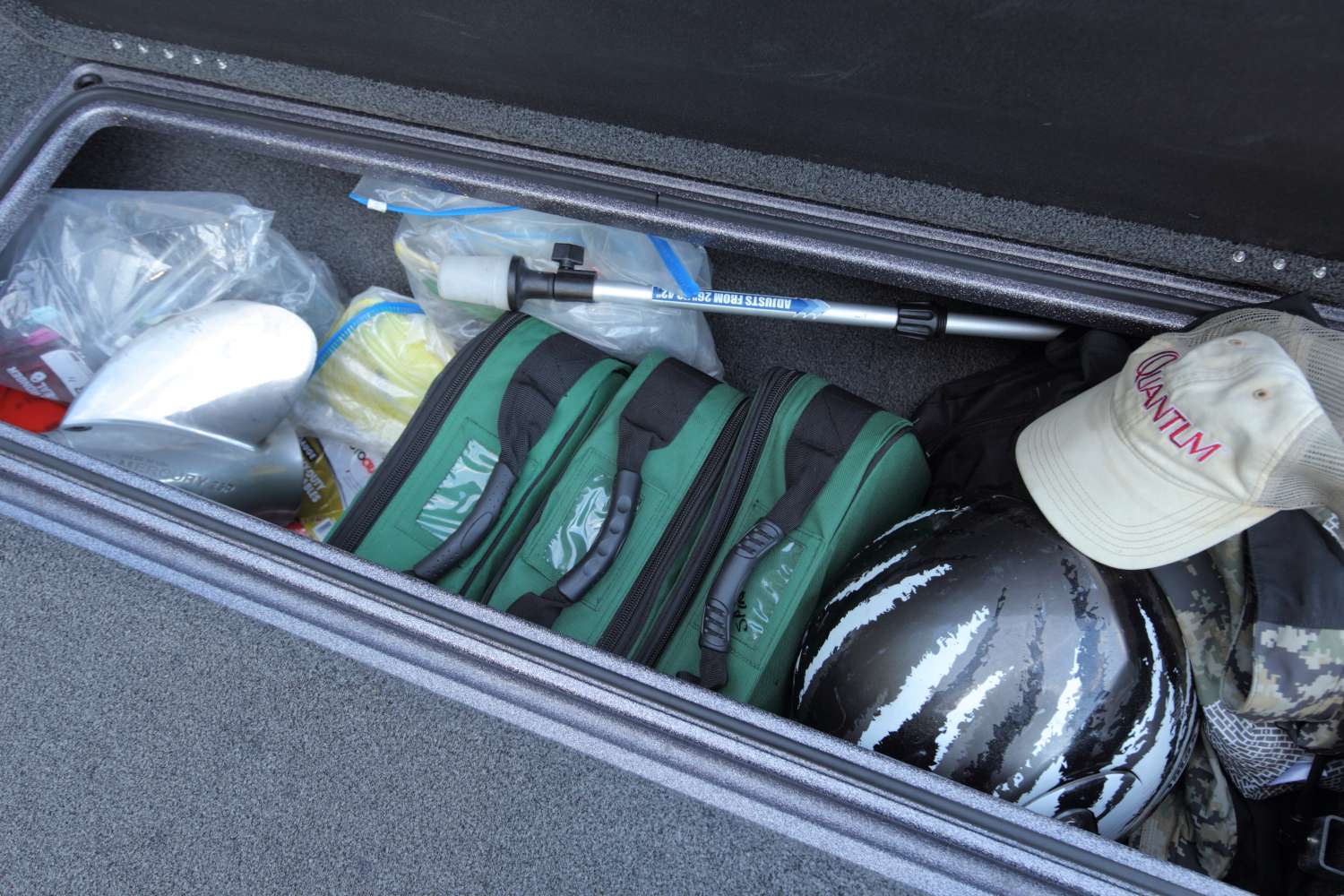 The right rod locker looks to be a catch-all for different items. Here, the three green bags hold Lee's spare reels.