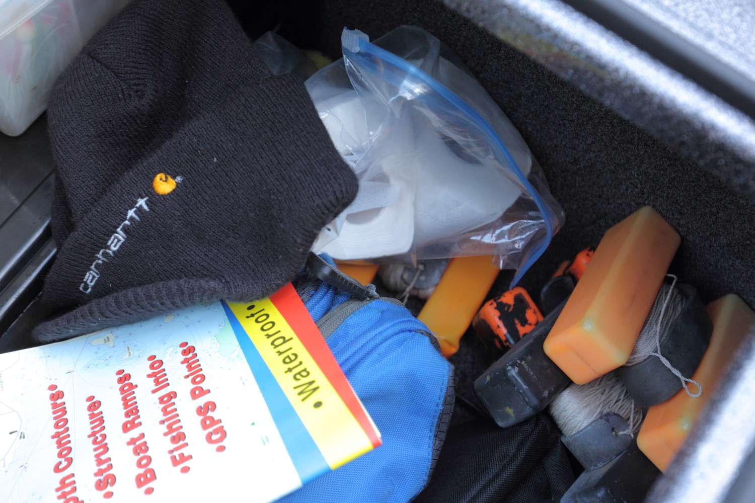 A Carhartt ski cap, toilet paper and marker buoys also fit in the compartment.