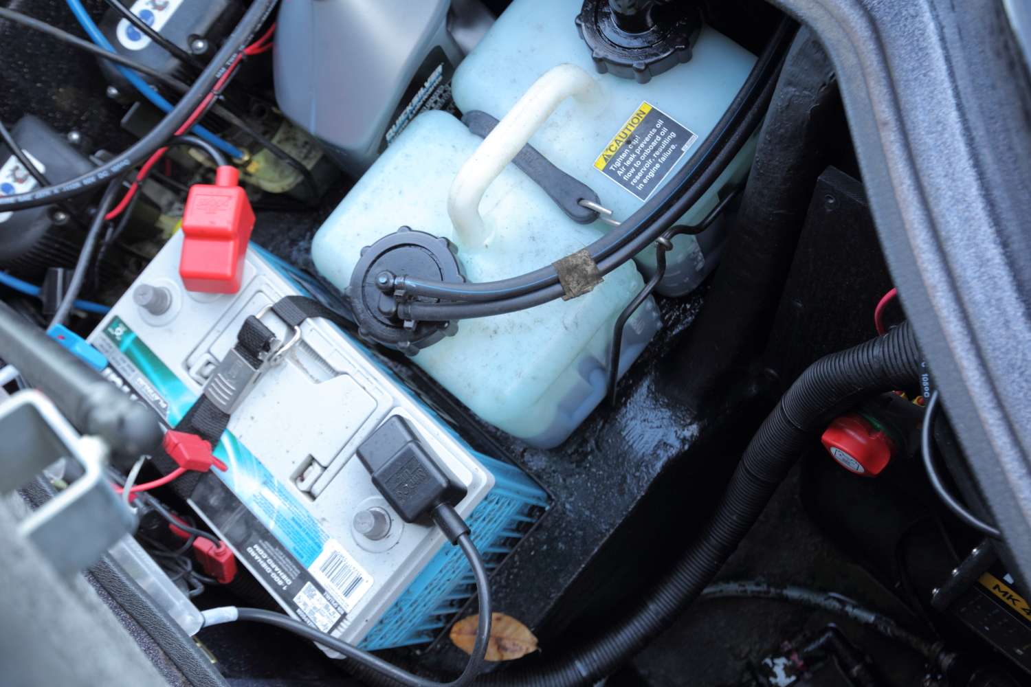 The rear of the boat has four DieHard Platinum AGM batteries and an extra bottle of oil.