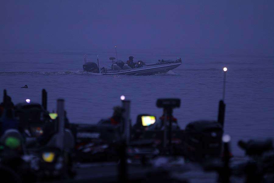 The fog thickens at daylight as the first flight of boats idles away from the takeoff point. Other boats await their turn as the day gets underway. 
