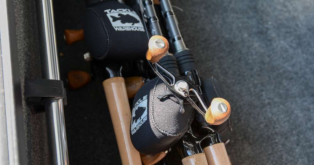 Inside one of his rod lockers are several brand-new 13 Fishing rod-and-reel combos, each reel covered by a Tackle Warehouse reel cover.