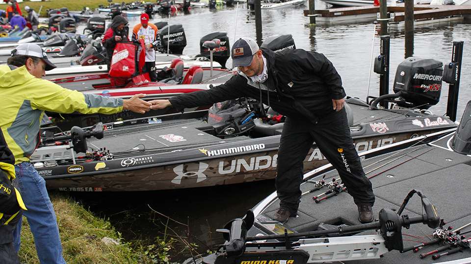 Jordan Lee arrives at the boat ramp and gets some assistance so his boat stays anchored against the shore.