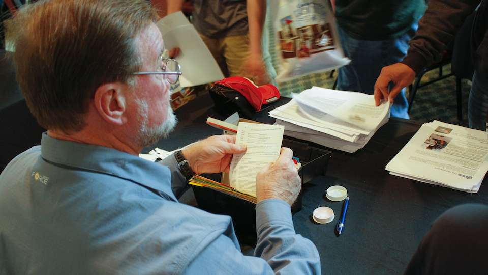 B.A.S.S. tournament official Max Leatherwood checks fishing licenses and gets anglersâ info.