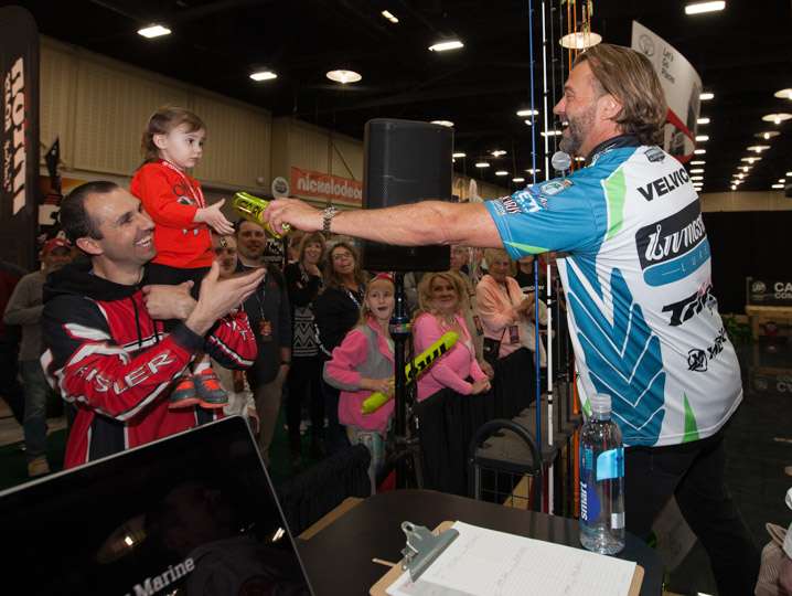Byron Velvick hands out Mercury Marine items at the unveiling of the new 115 Pro XS Fourstroke.