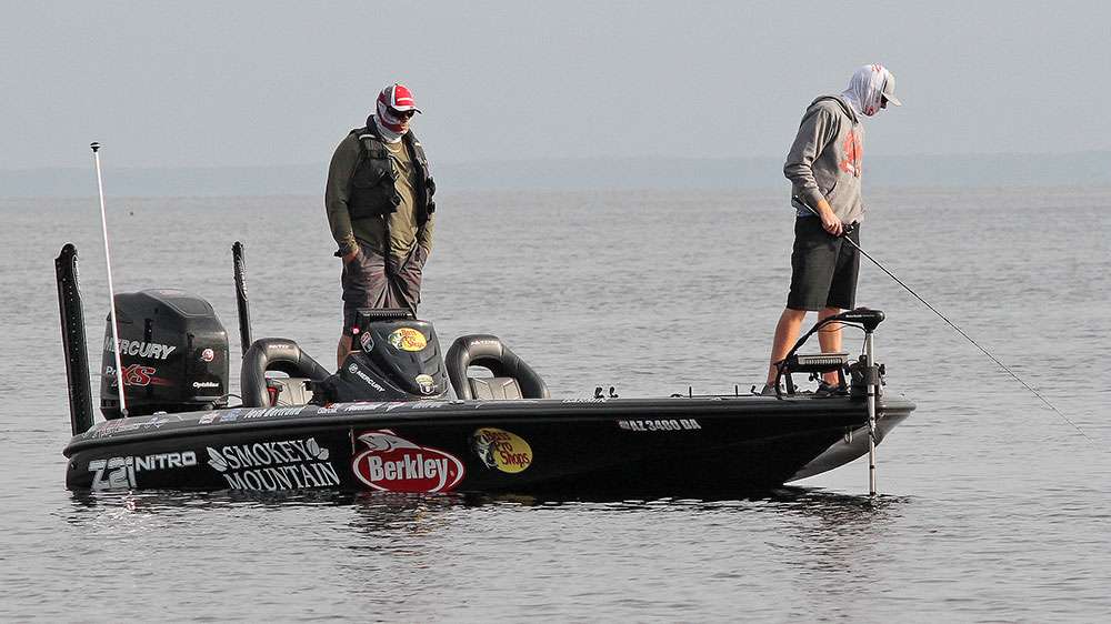 Josh Bertrand continues to peer into the dark water looking for bass on beds. 