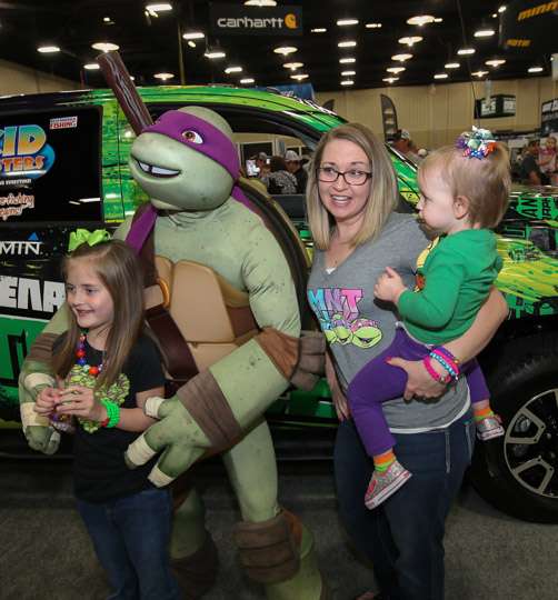 Mom and kids pose with the smartest Teenage Mutant Ninja Turtle, Donatello.