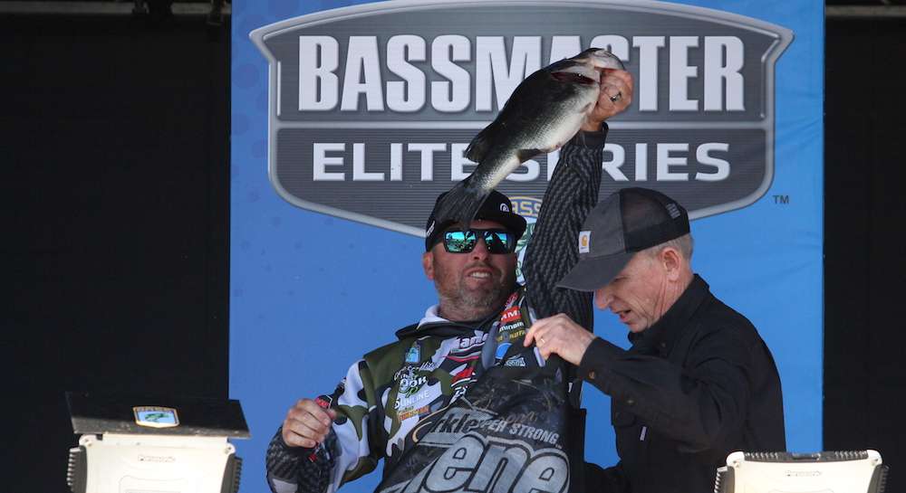 Hite holds a nice one up as Tournament Director Trip Weldon wrangles the remaining bass.