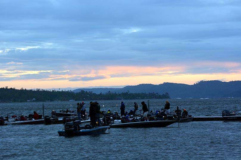 The sun rises in the east with the Tennessee River in the foreground. The anglers travel toward the sun to access the lake.
