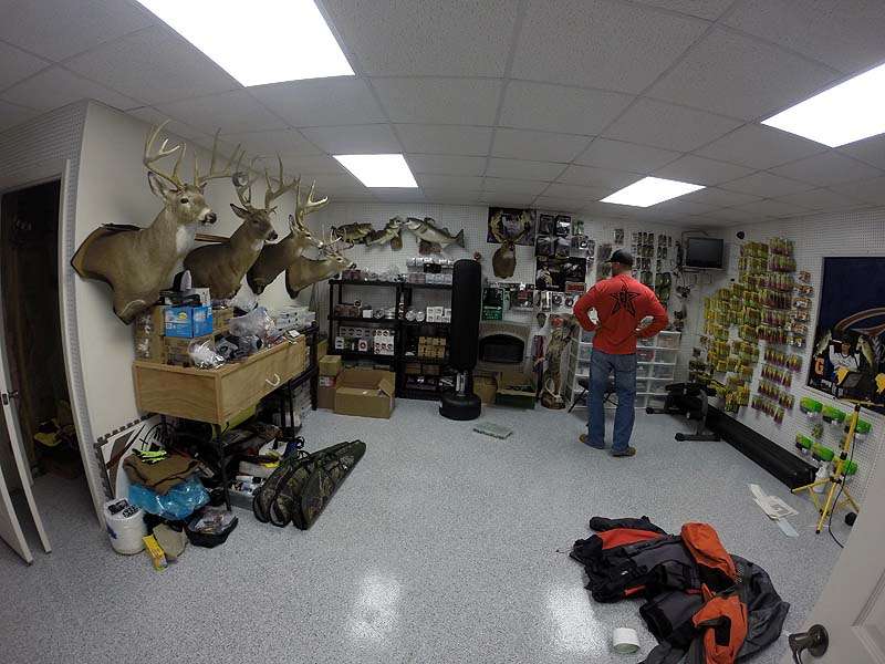 This interior room is a hidden jewel that is the envy of any man cave. Mounts of trophy bucks and bass line the walls, along with packaged lures neatly organized on the pegboards. 