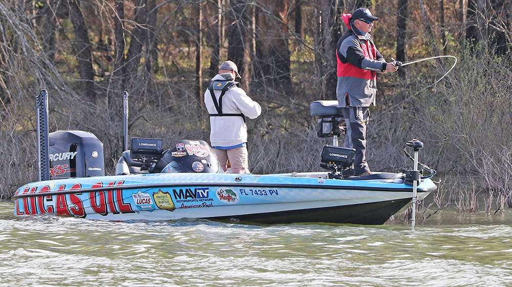 Darrell Pons and his co-angler Blake Oswalt work flooded brush piles for largemouth bass. They are harder to find when compared to the lake's abundant spotted bass, but the largemouths typically weigh more. 