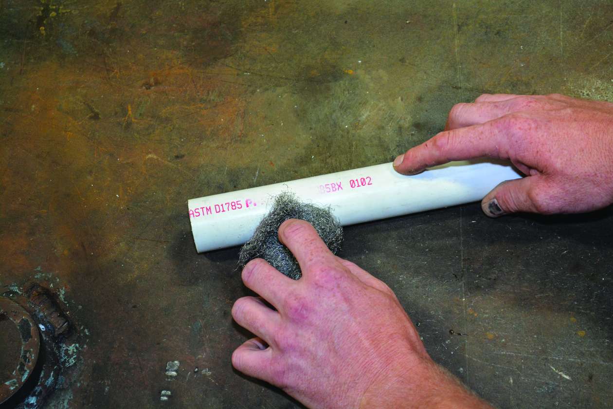 Remove lettering from the PVC pipe with steel wool.