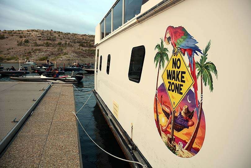 Irony surrounds this houseboat moored at the takeoff site. The final boats to be lined up idle past. 