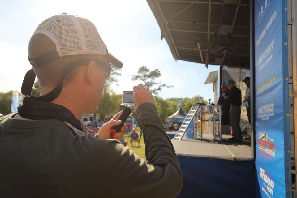 A Bassmaster Marshal shoots some photos/videos with a GoPro.