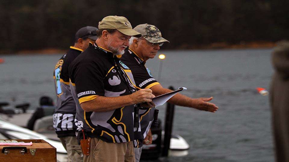 B.A.S.S. officials, including Max Leatherwood, conduct final safety checks of the boats prior to takeoff. 