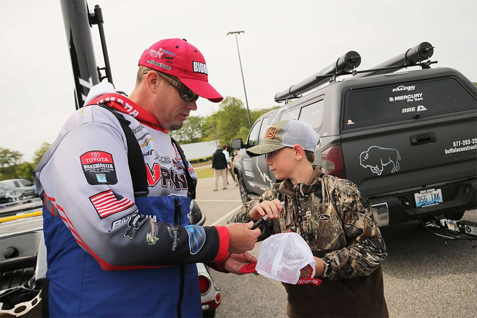 Keith Combs signs an autograph for a young fan.