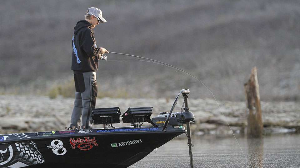 Brainard eyes the fish in the water.
