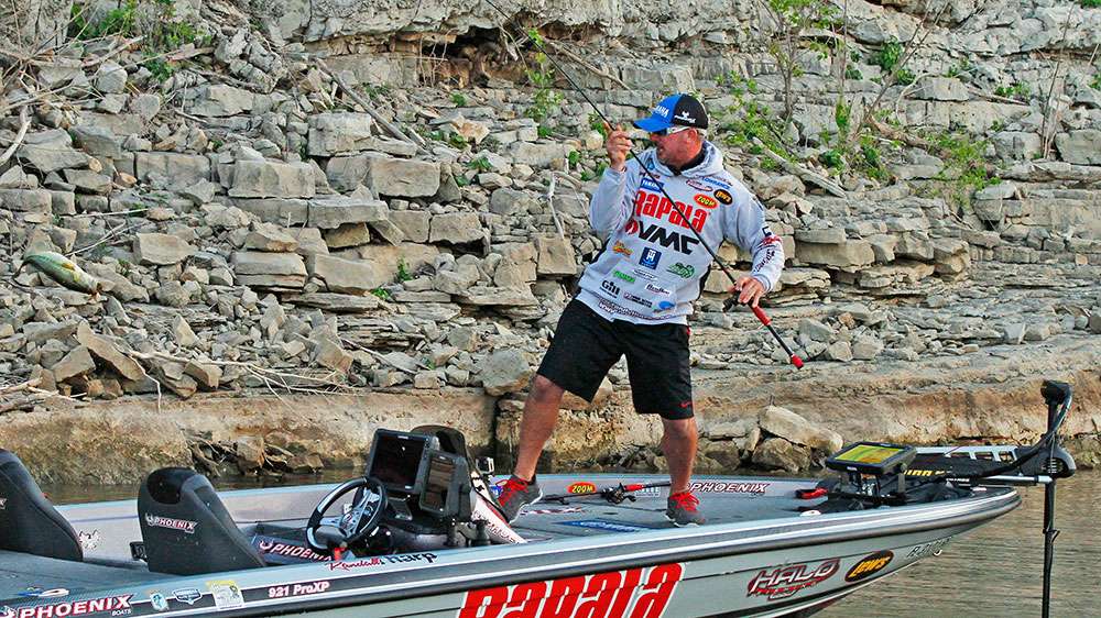 Tharp's first fish of the day eats his jig almost as soon as it hit the water, and he flips the fish into the boat. 