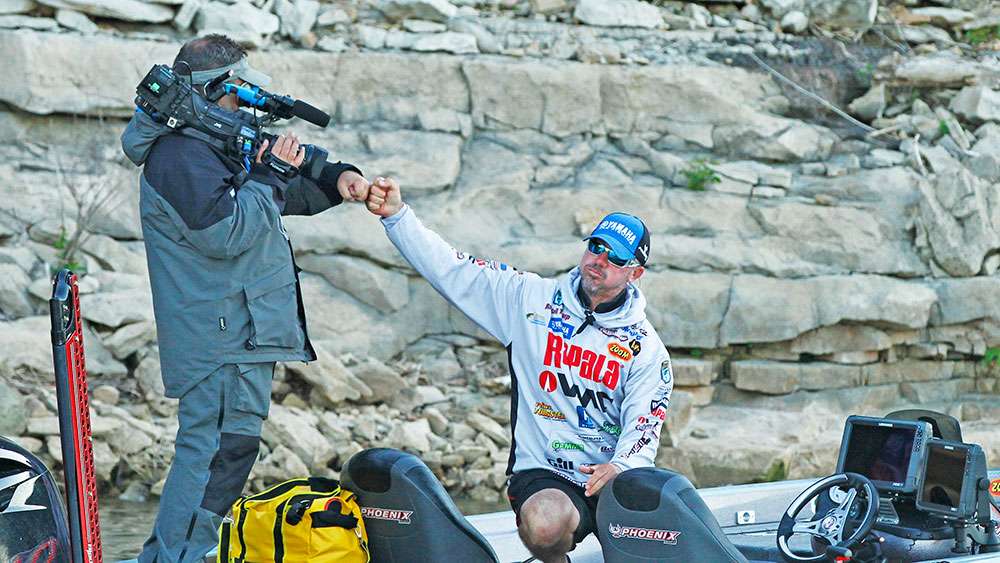Happy with his early progress, the Bassmaster LIVE cameraman exchanges knuckles with Tharp. He's feeling good so far. 
