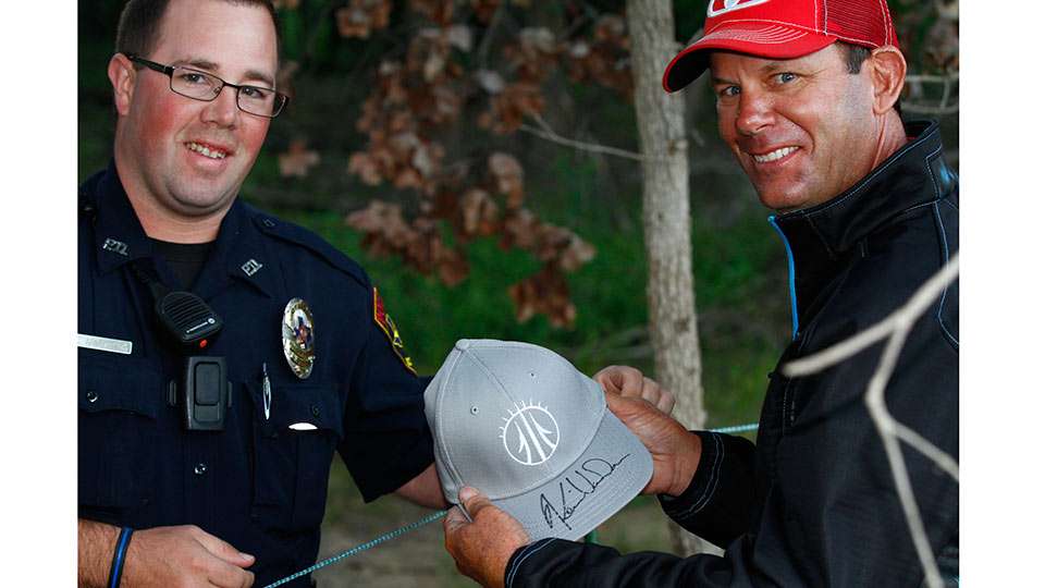 Kevin VanDam shows off his signature for a police officer  in attendance.