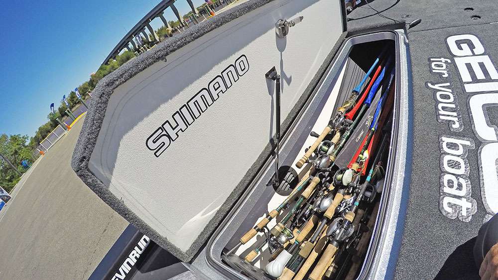 Beneath the port side storage locker are a pile of rod-and-reel combos. 