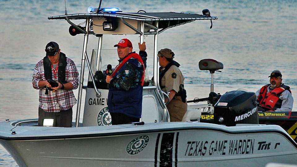 Dave Mercer hitches a ride on a game warden boat.