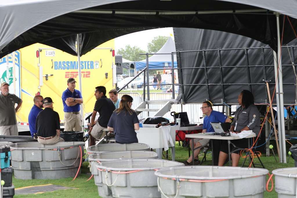 Behind the stage, the B.A.S.S. communications and event team hold a quick meeting to prepare for 50 anglers weighing in.