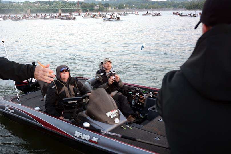 A non-boater catches the floating key fob with a boat number. Each boat is assigned a number to match the check-in time. 