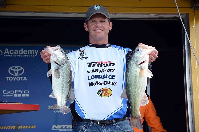 Brian Gunner of North Carolina poses with two bass from his limit. 
