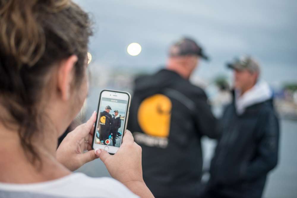 Fans take photos and videos on the dock of their favorite pros. 