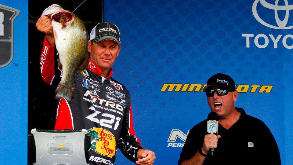 He holds up a nice Toledo Bend bass for the crowd.