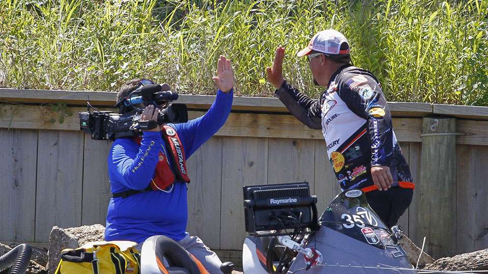 After putting that fish on the big-side, he high fives cameraman Eric Kaffka.