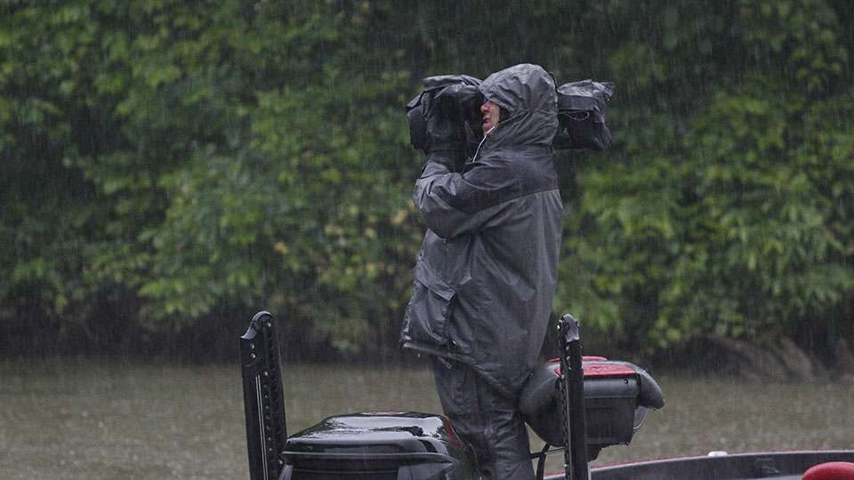 Cameraman Eric Kaffka keeps working through the rain as well.