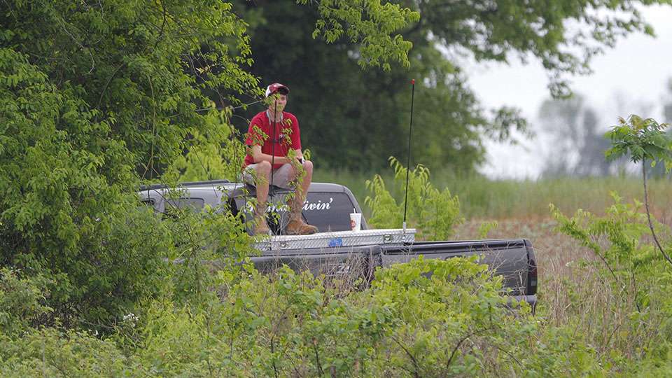 A young fishing fan sits on top of his truck so he can get a better view of Lefebre going to work.