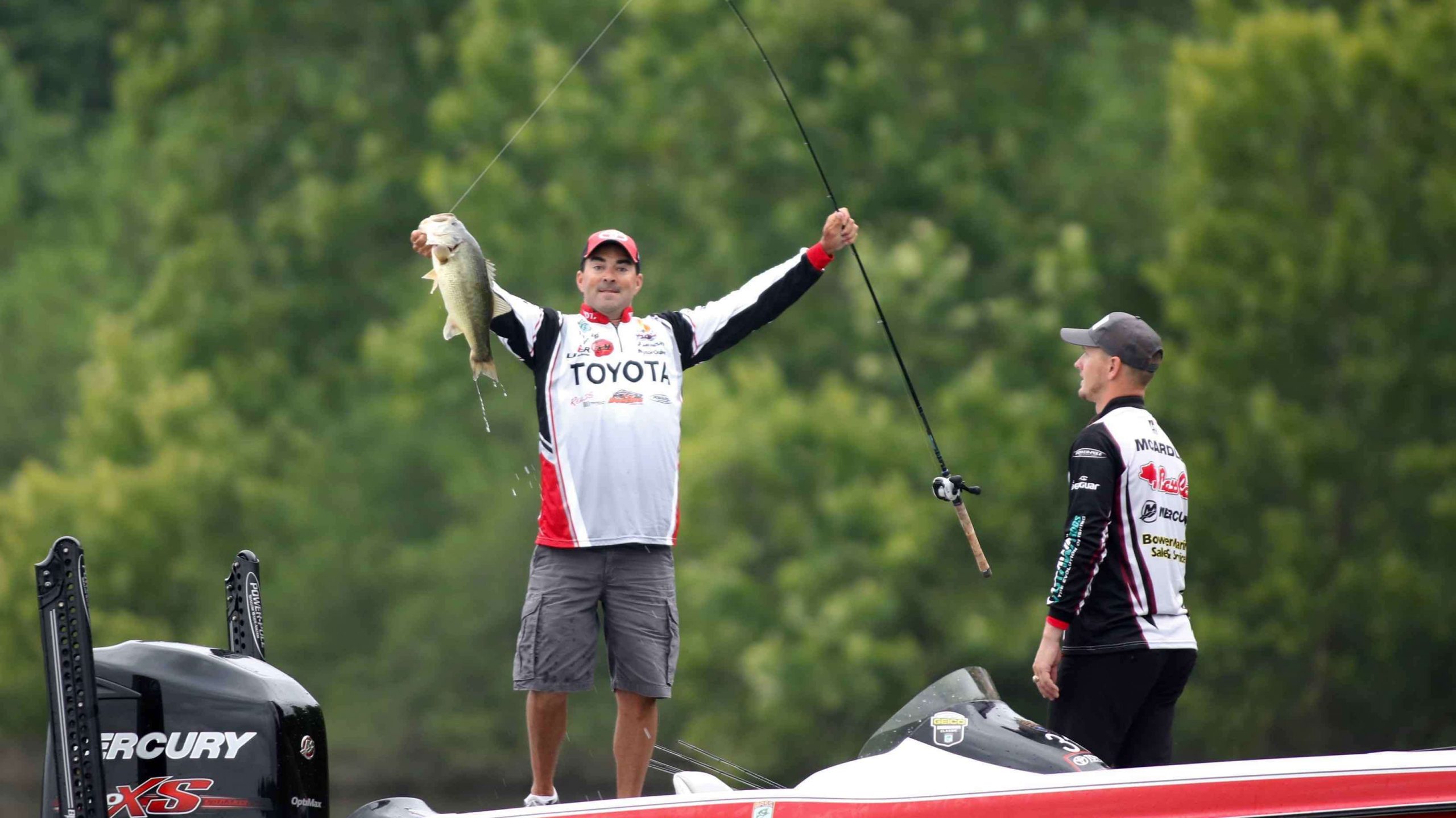 Teb Jones strikes a triumphant pose with a 4-pounds-plus fish to start Day 3 as co-angler Matthew Mcardle looks on.
