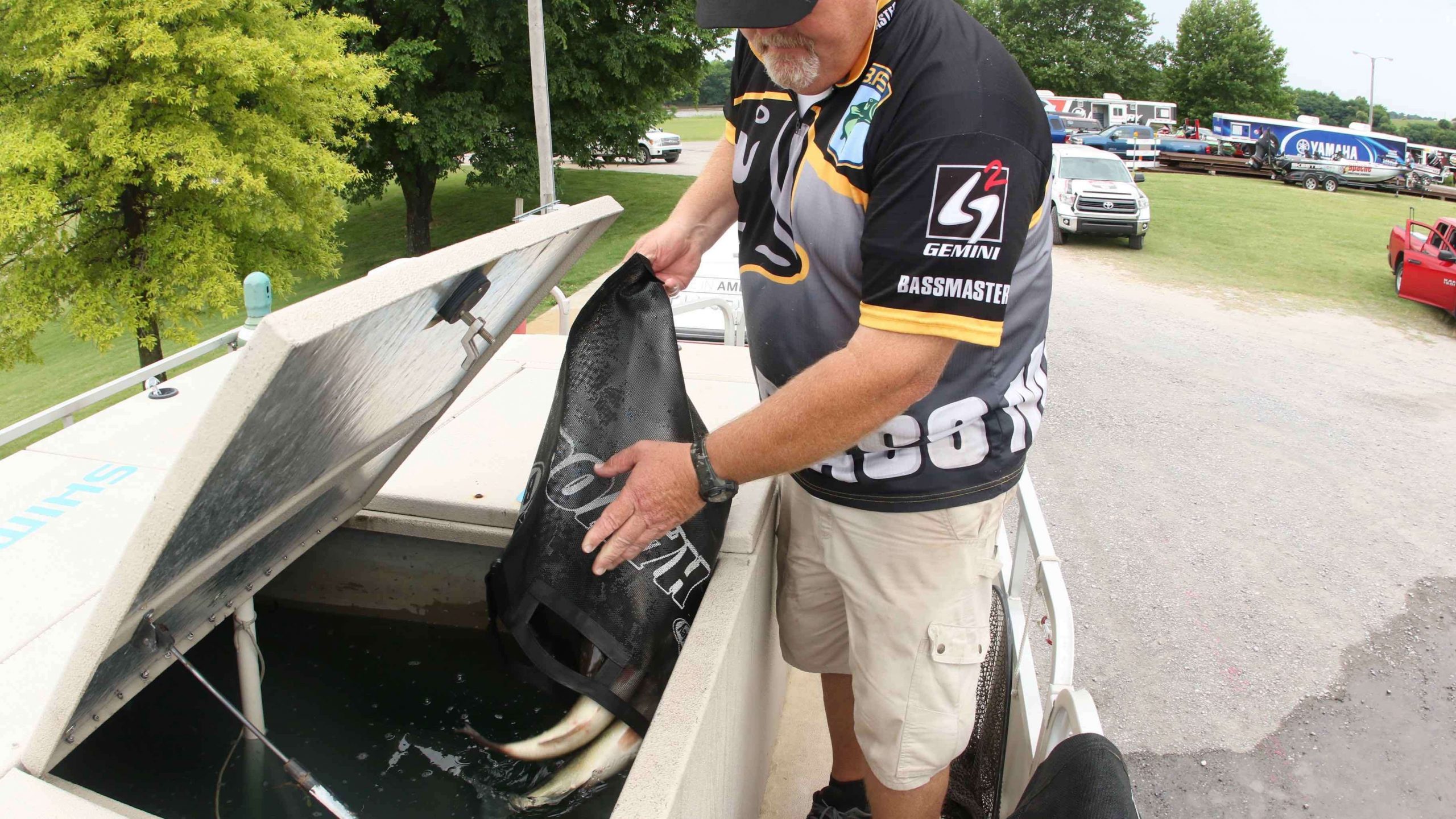  Norris adds a few more lively bass to the release boat tanks. All but 12 of the 874 fish weighed-in were released alive.