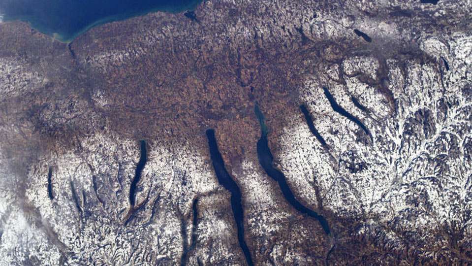 As glaciers melted, water filled the deep trenches. In mid-state New York, a series north to south troughs were formed. They looked like two hands reached down and gouged them, thus the name Finger Lakes.