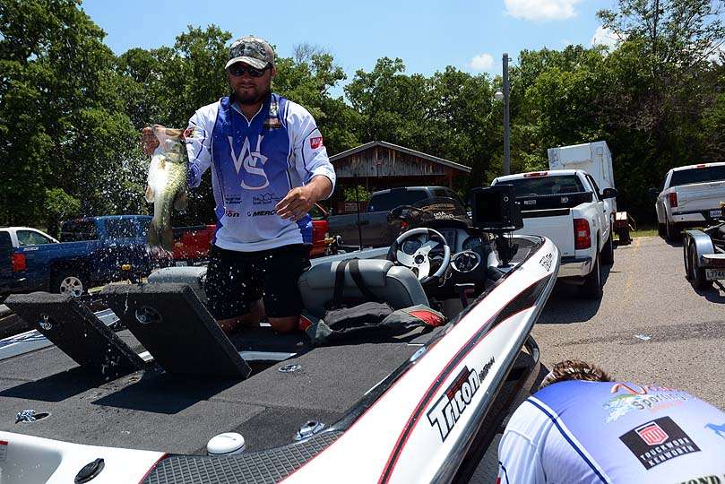 Forrest Sears brings out of the livewell one of the 5 bass weighed by Wallace State Community College. His partner Greg Dean stands by with the weigh-in bag. 