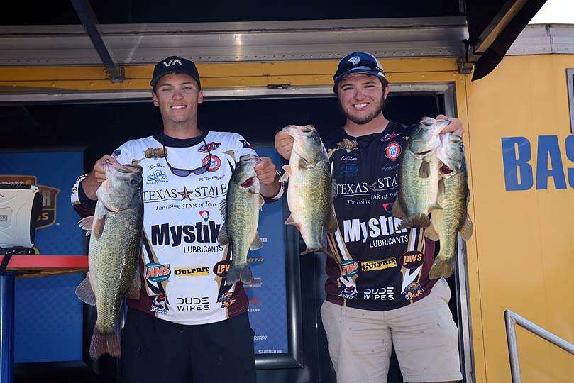 Evan Coleman and Sam Stone of Texas State University pose with the tournamentâs heaviest catch thus far. The limit weighing 19-2 is anchored by Stoneâs big bass weighing 7-11. 