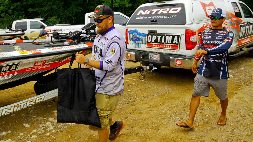 Tyson Scott carries the bag of fish he and his partner Chris Zaldain would weigh. 