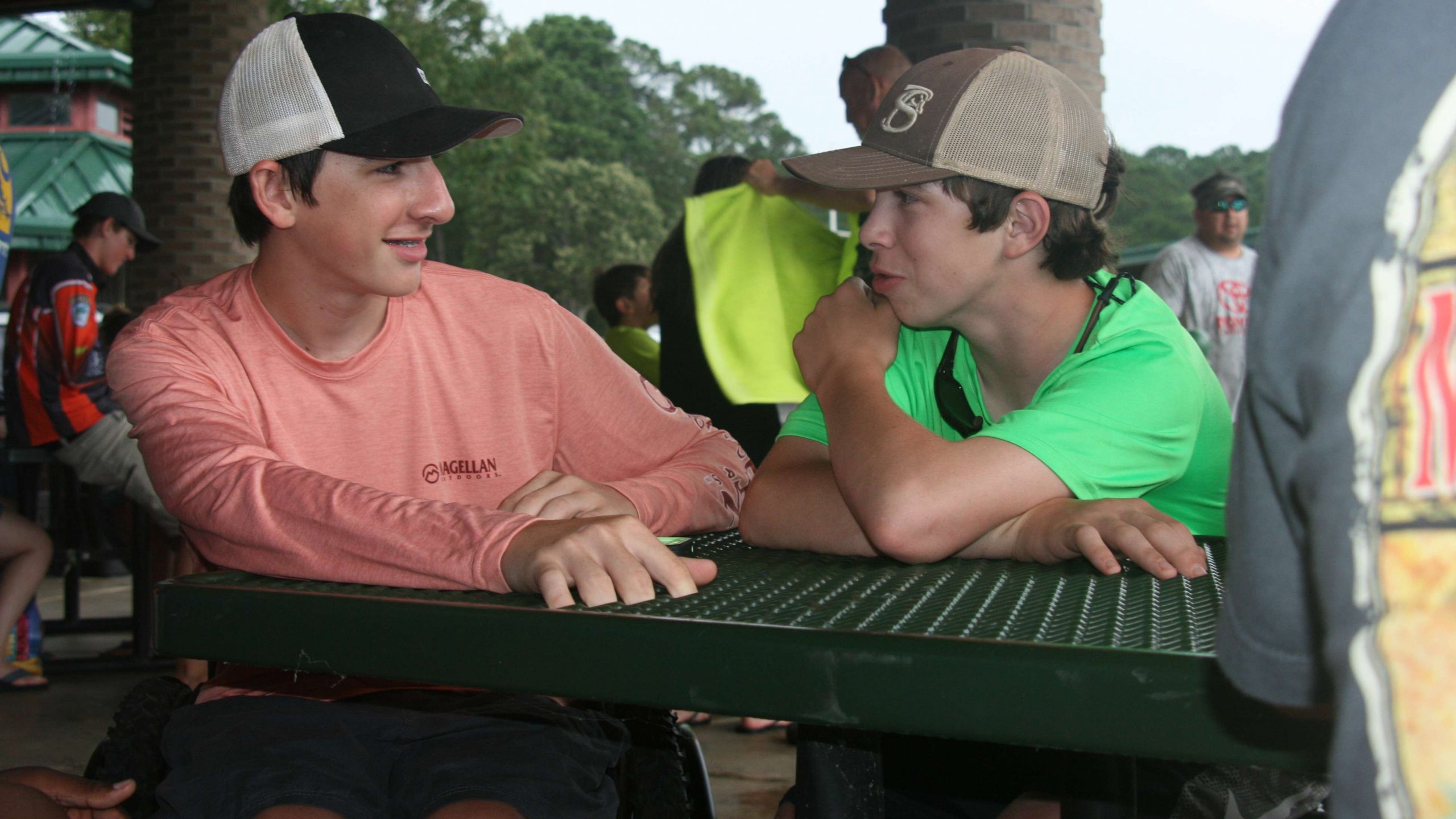 Tucker Roe and Hunter Owens of Natchitoches (LA) Central High chat during the rain delay.