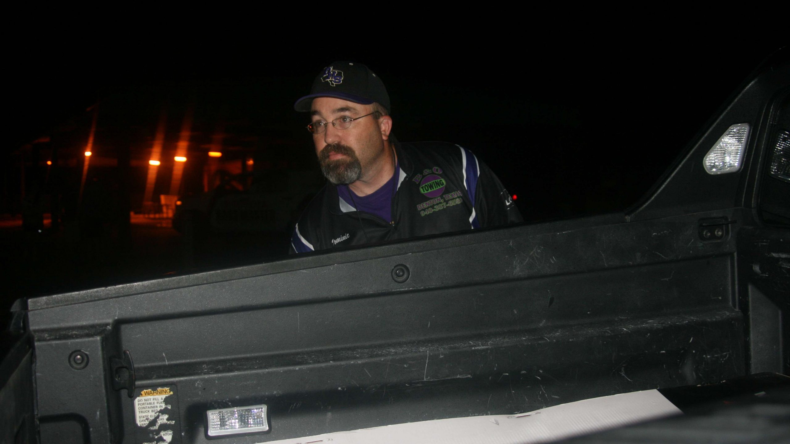 Dominic Falcinelli, the Denton High coach, gets ready to back down the team in the early morning hours.