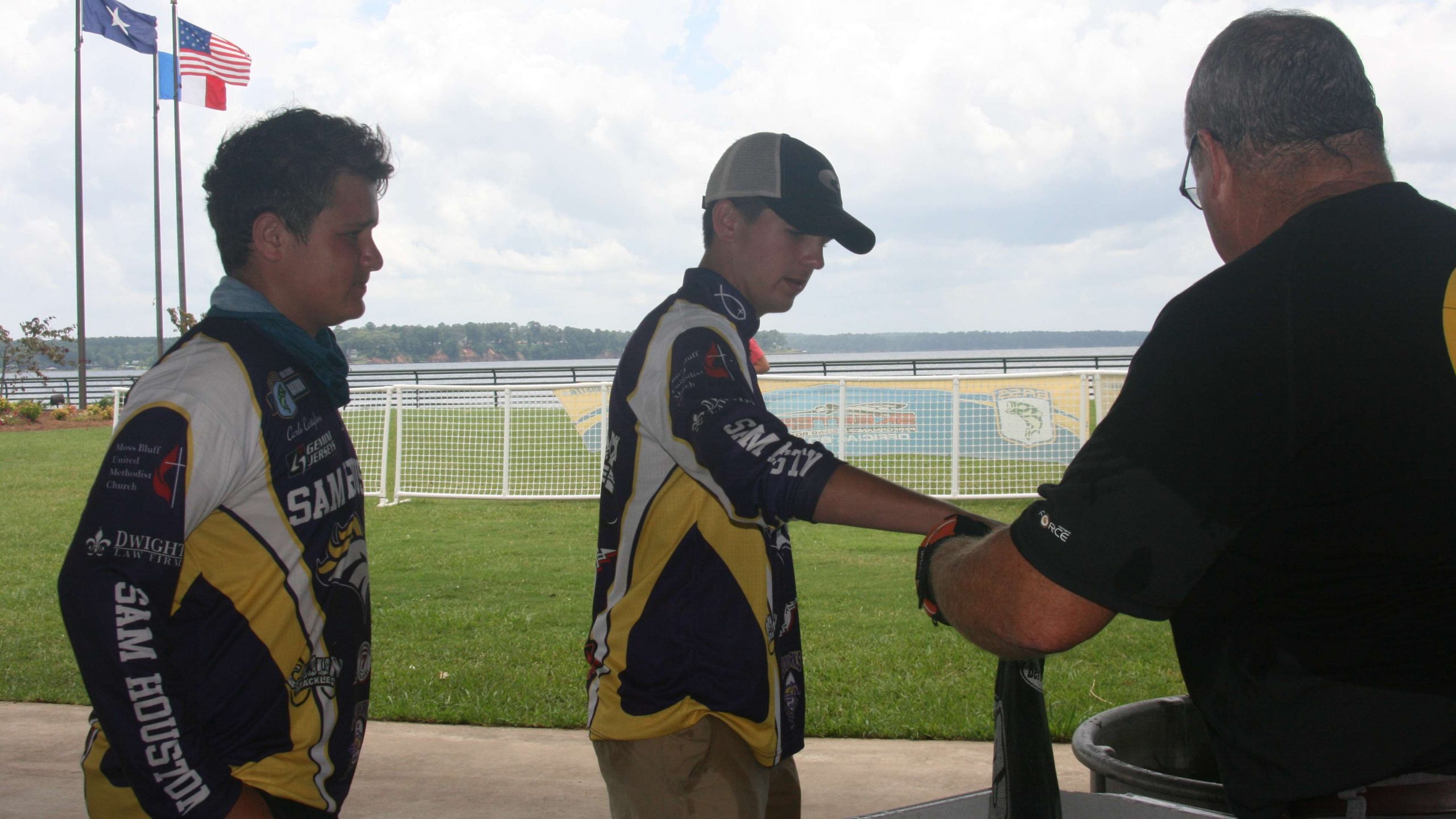 A pair of Sam Houston High School anglers present their bag to be weighed backstage.