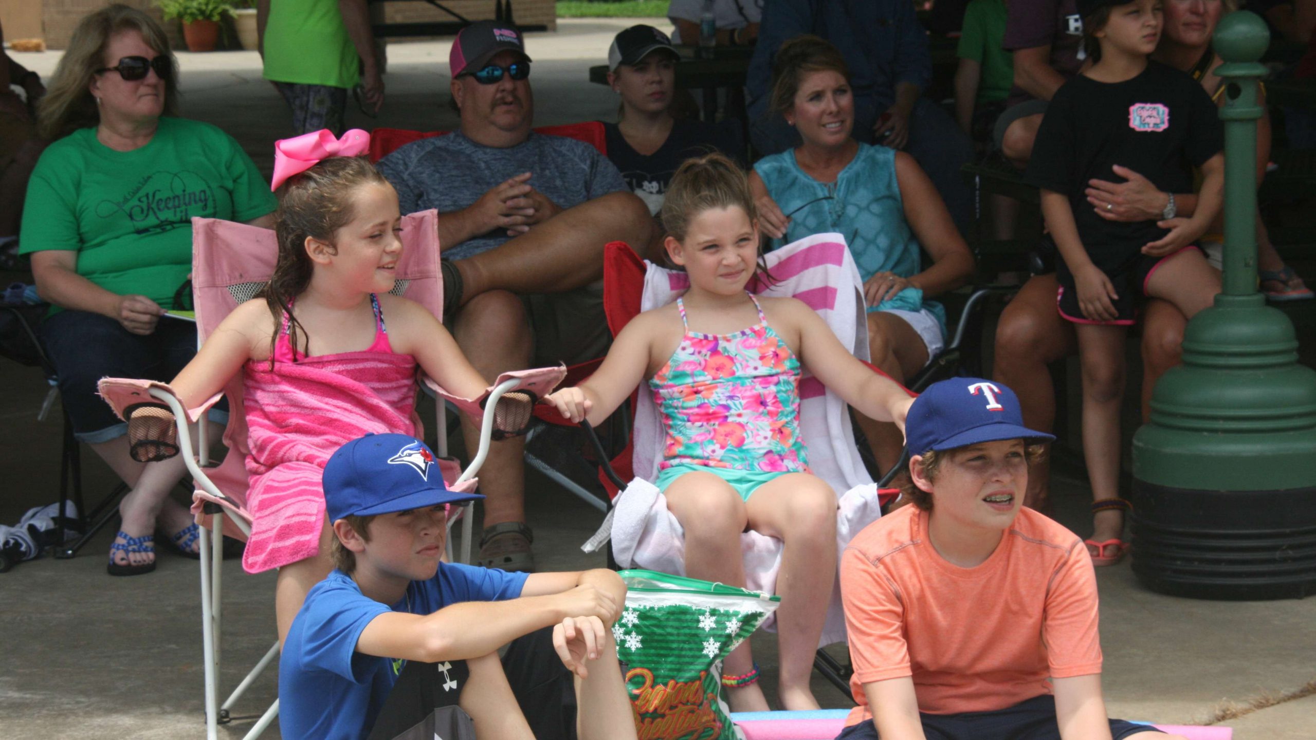 Young anglers attract young fans. Here, a group seeks shade under a pavilion at Cypress Bend Park before the action begins on stage.