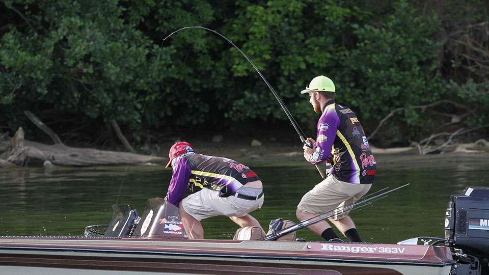 Scott lowers the net to the water and scoops up the fish as Lenske keeps pressure on the fish.