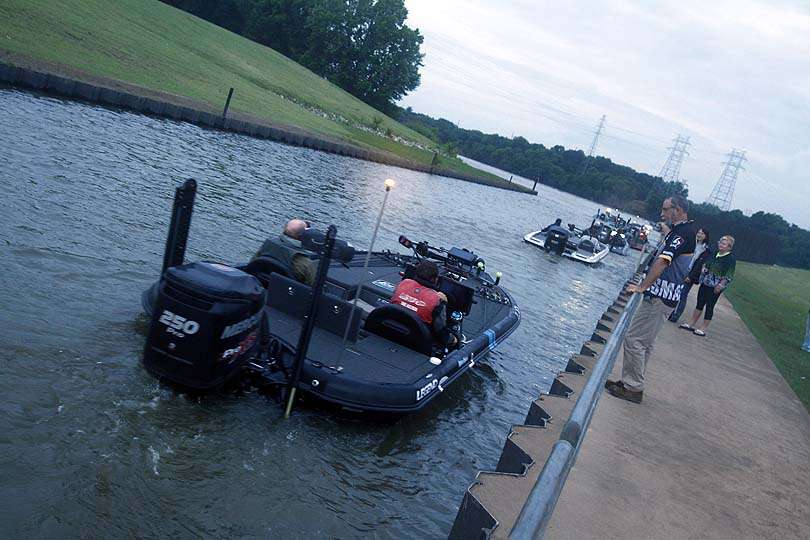 The line of boats leads out to the river near Muskogee, Okla. The anglers will compete for the next three days. 