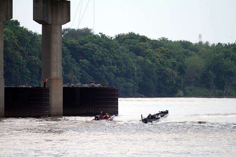 The boats slow under the bridge for a reason. Bridges in Oklahoma are no-wake zones.