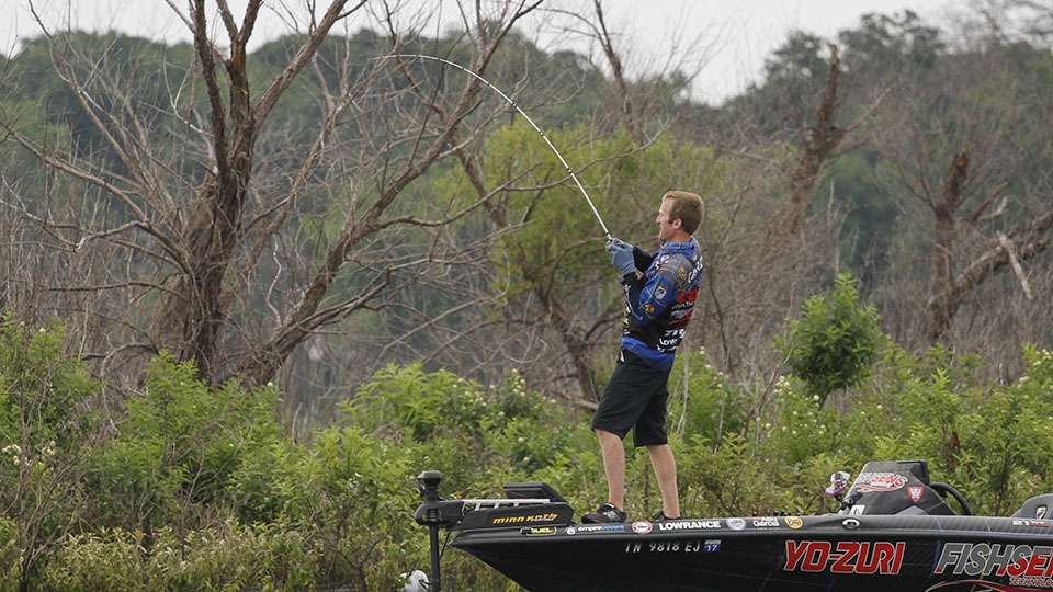He, then, jumps on the trolling motor and tries to speed up towards the bushes where the big fish got wrapped up inside.